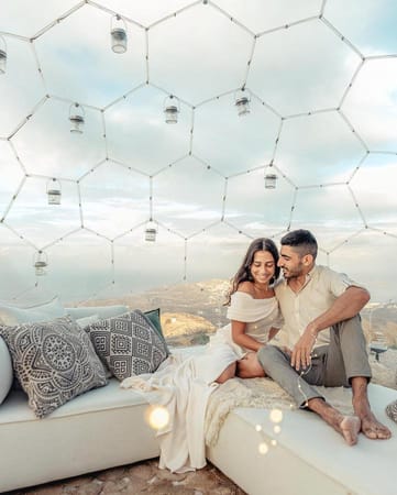 Couple cuddling on a sofa inside the dome