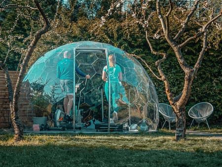 A couple working out in a garden igloo gym