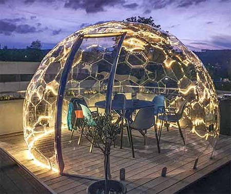 Illuminated garden bubble pod by night