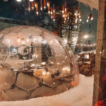 Illuminated dining dome in the snow
