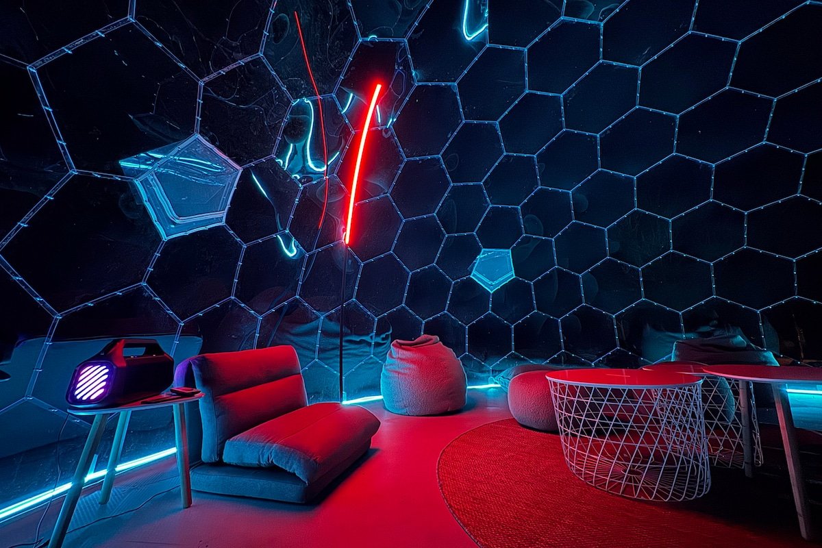 Geodome neon lounge gaming room interior at night