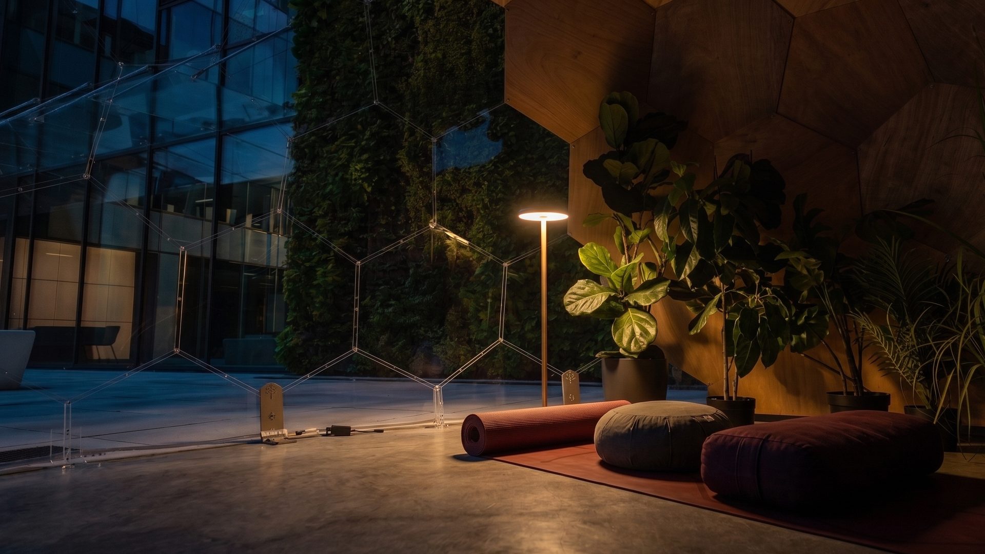 The same Wellness Dome interior after dark, lit by a single warm floor lamp