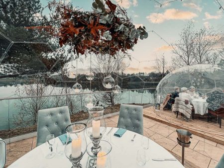Clear dining pods by the lake in Winter