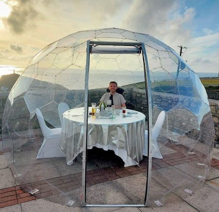 A man sitting in a dining pod