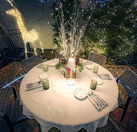 Illuminated outdoor table setting in a dining pod