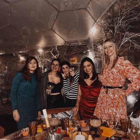 A group of friends dining in a dome
