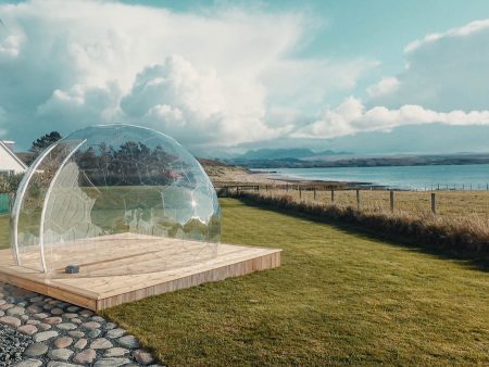 Transparent garden pod by the sea