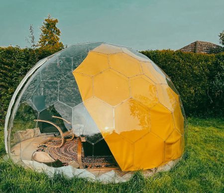 A garden dome in summer with a sun shade sail