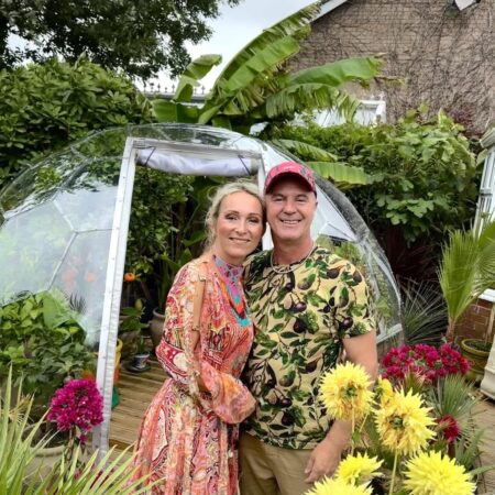 Ania and Duncan in front of their tropical greenhouse dome