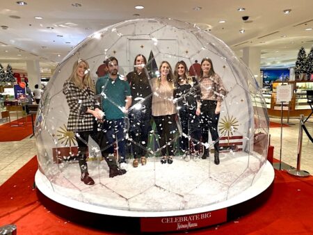 People having a photo inside a life-size snow globe in a shopping centre