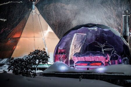 A glamping pod by night in a winter scenery