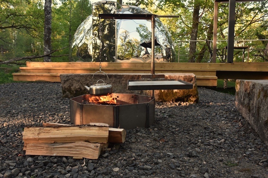 a glamping dome and a fire pit