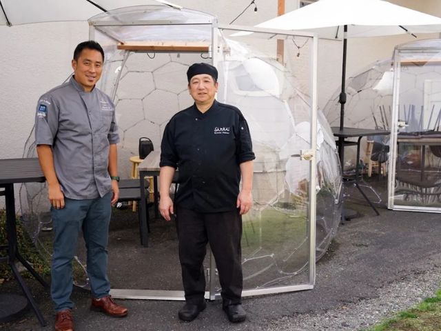 Chefs from SanKai Sushi standing beside clear Hypedome dining domes set up in the restaurant’s outdoor area