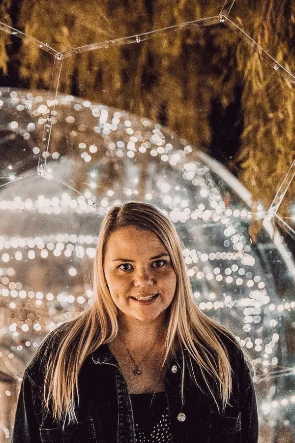 Blonde woman against the illuminated dining pod