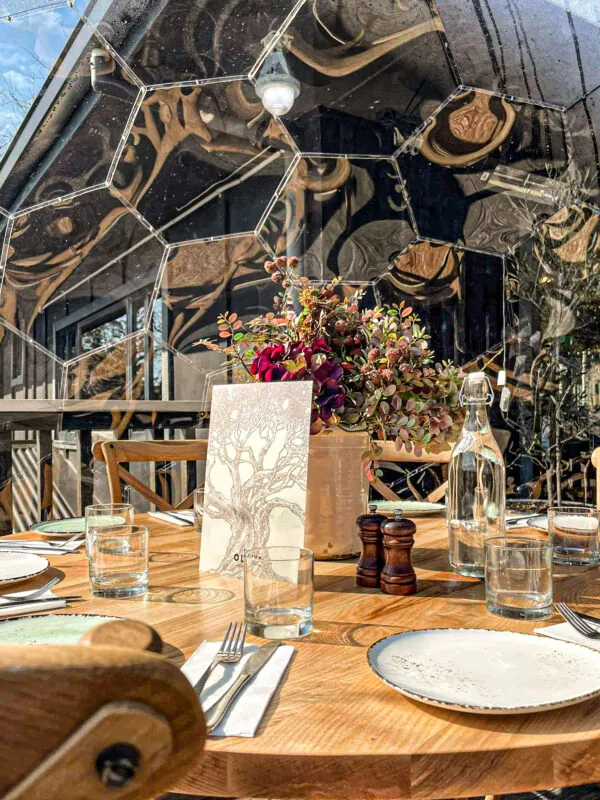 Wooden table ready for meal inside the dining dome