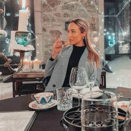 Woman enjoying a drink in a dining dome