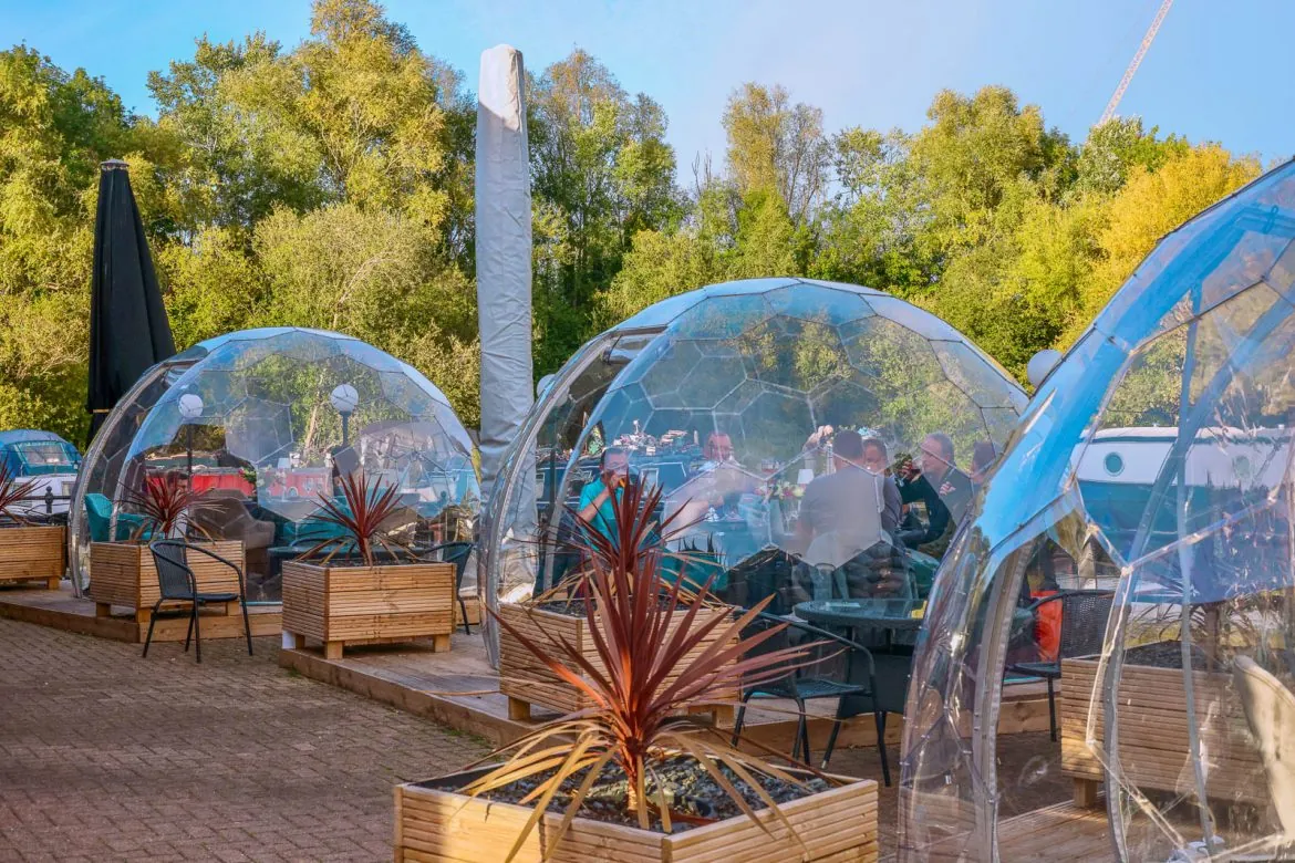 Outdoor dining area with clear pods