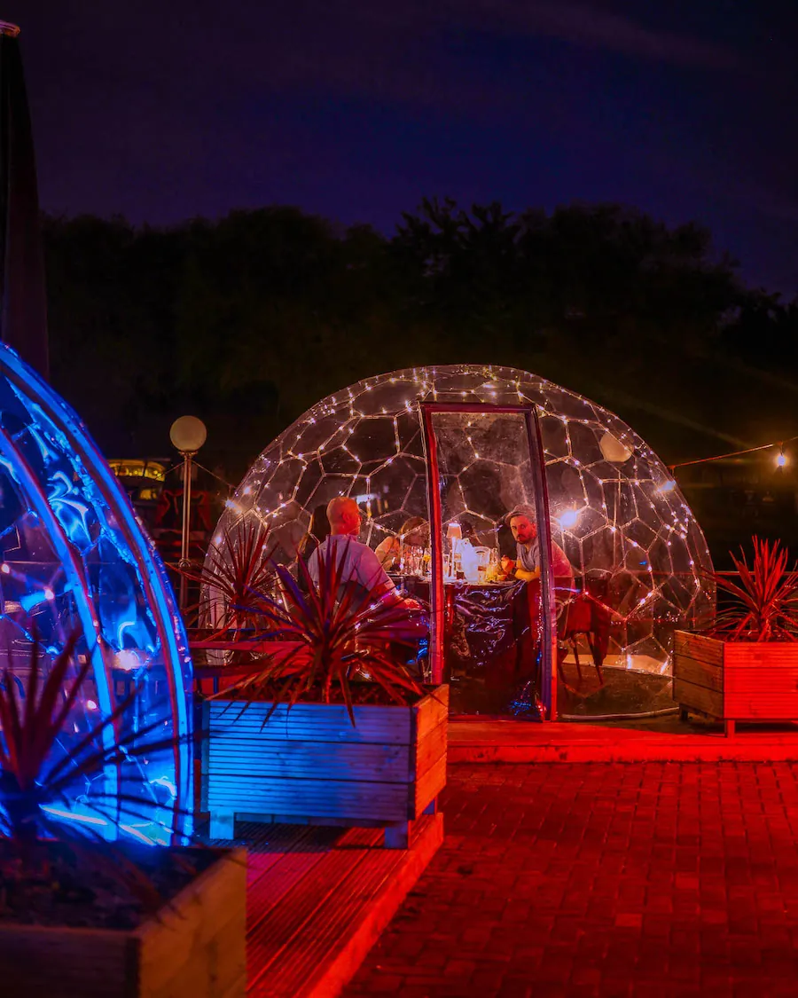 red and blue illuminated dining pods