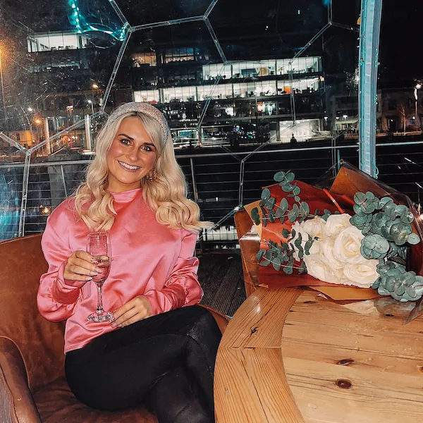 A woman celebrating in a dining dome