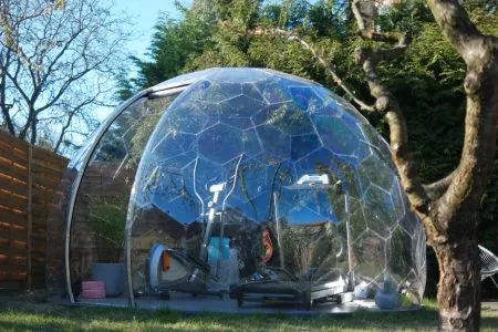 Outdoor gym in a garden dome with workout equipment inside