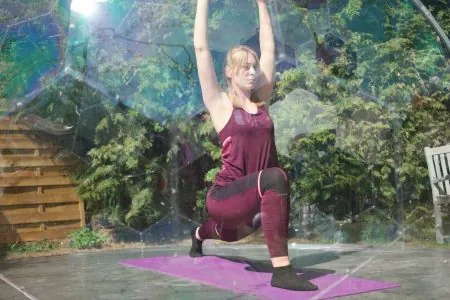 A woman practising yoga in an outdoor yoga room