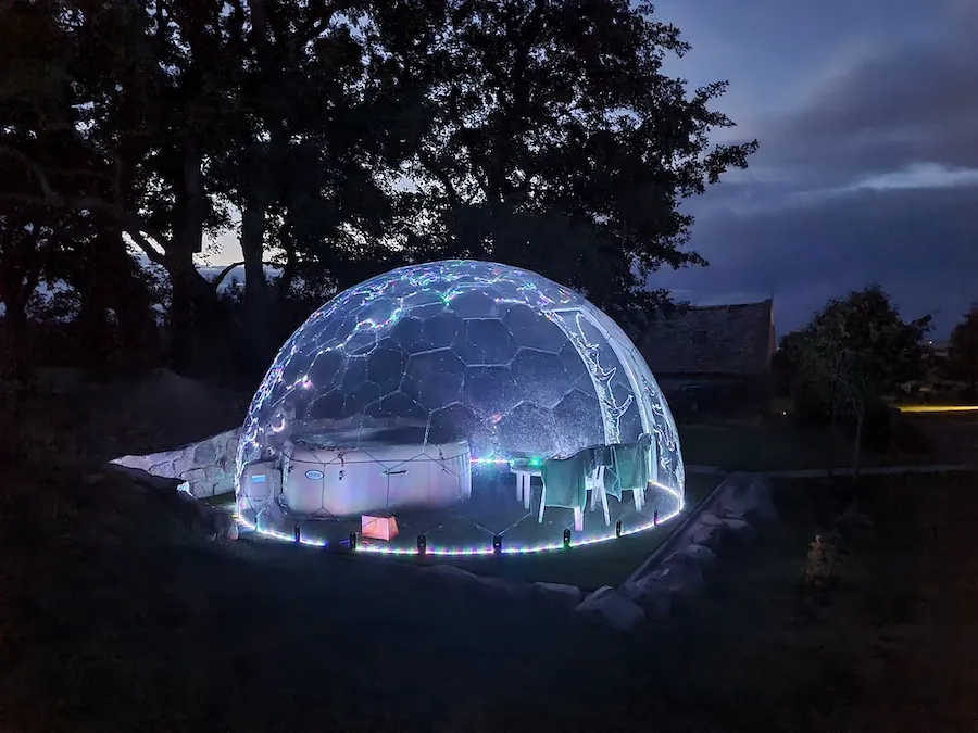 Illuminated hot tub canopy by night