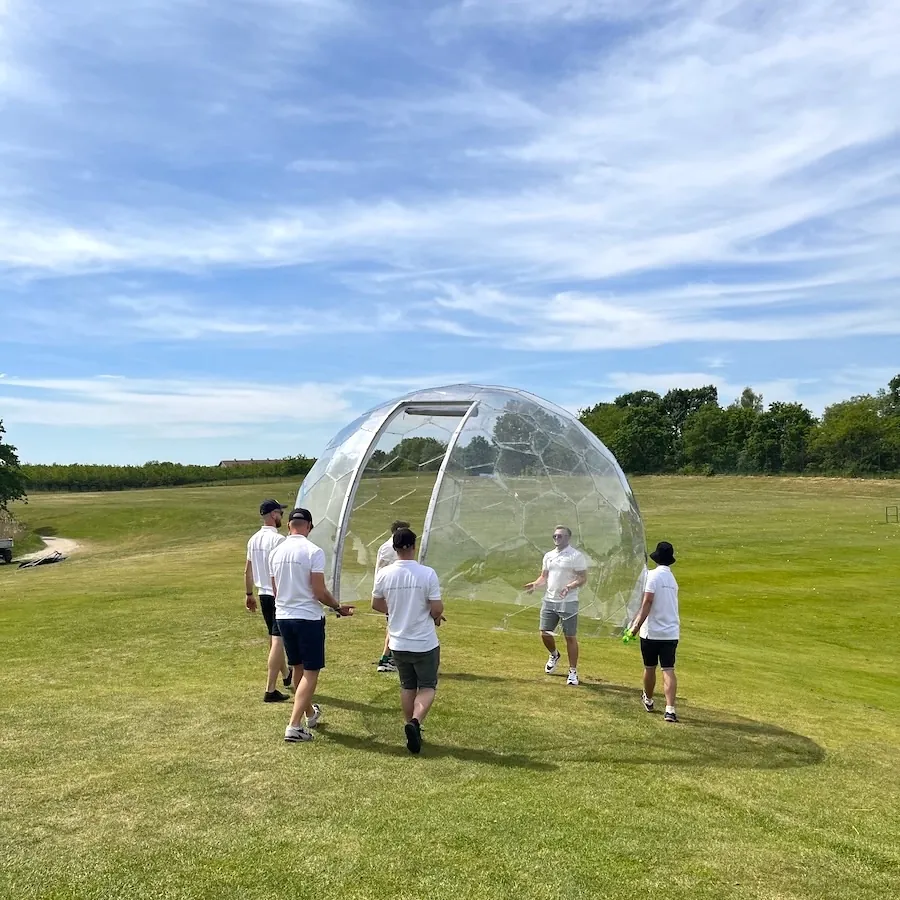 A group of men carrying Hypedome garden dome