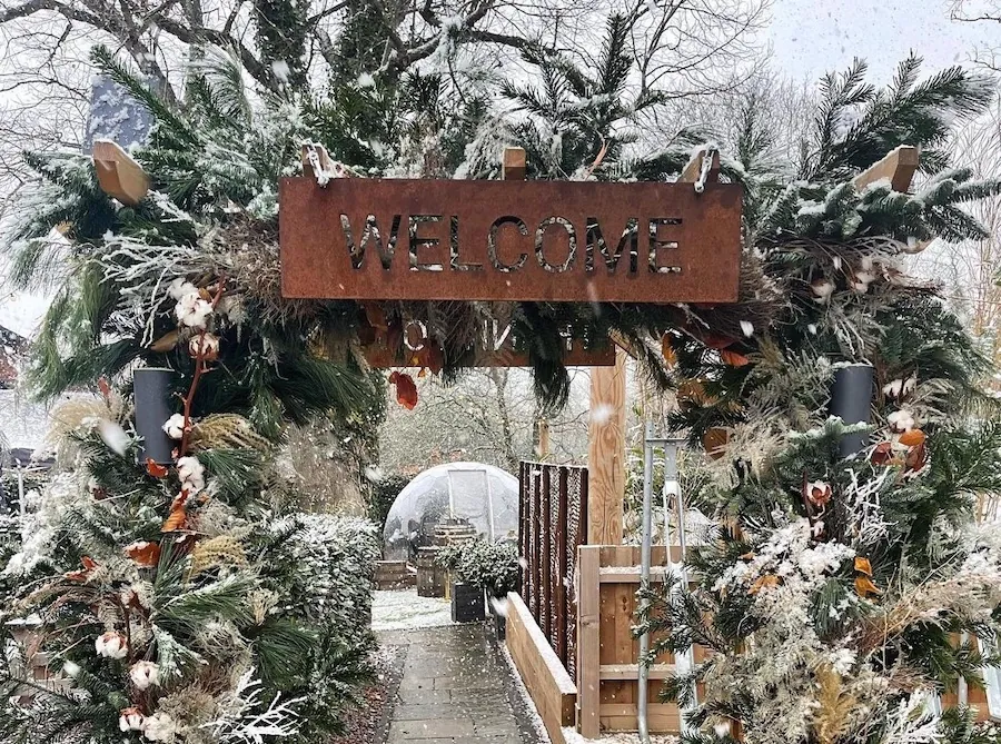 Outdoor space with winter decorations and a giant snow globe