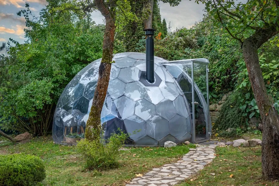 Glamping dome with a stove and chimney