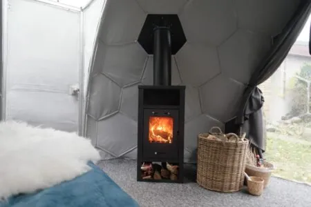 Wood burning stove inside a glamping dome