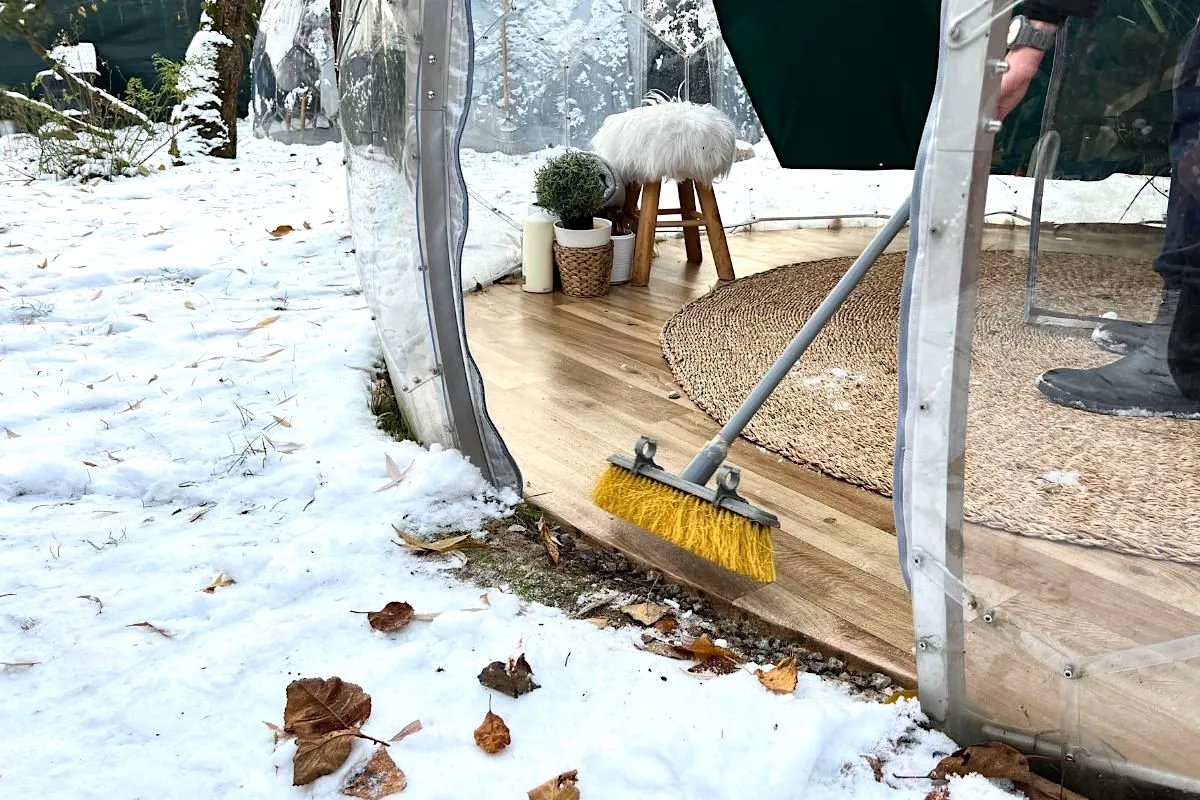 Sweeping out leaves from the garden dome for the winter