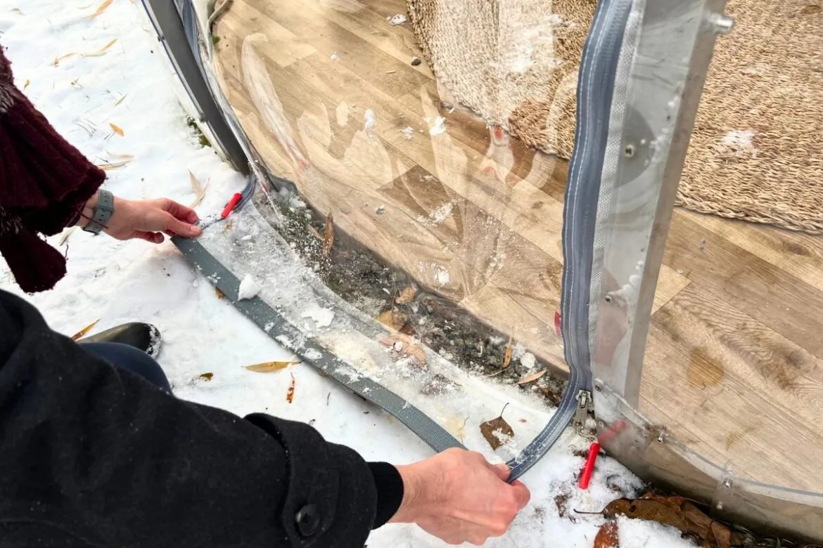 Securing the rollable membrane door to prevent any snow and rain from getting in your dome in winter