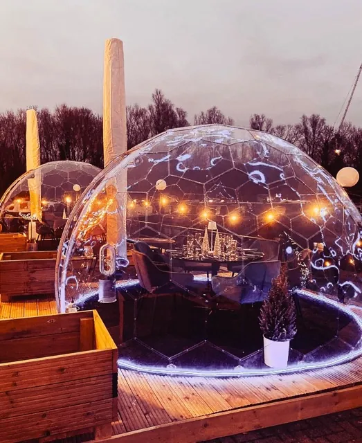 Dining dome with Christmas decorations inside, with lights and a Christmas tree