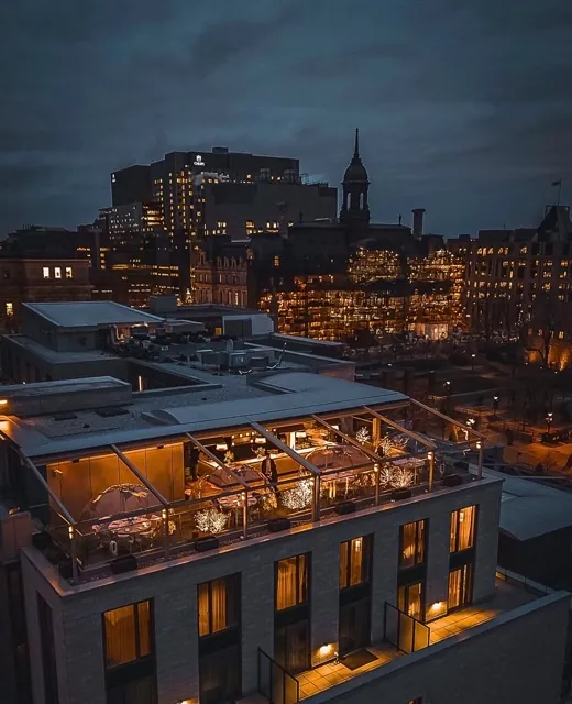 A restaurant on the rooftop with dining pods decorated for the Christmas time