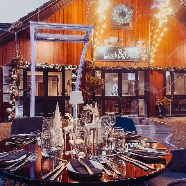 A table inside a dining dome, with Christmas ornaments and lights.