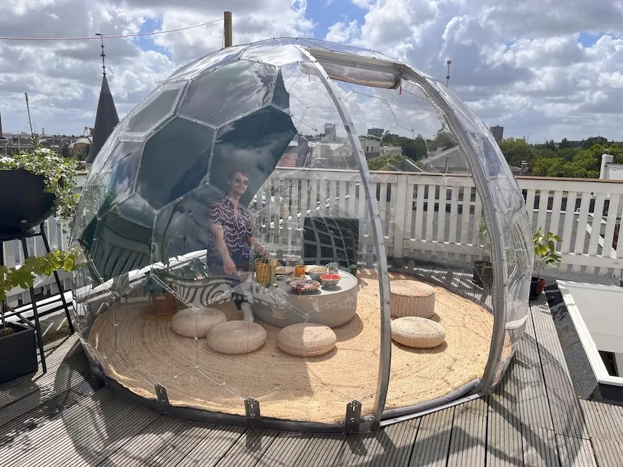 A man sitting in a dome on a rooftop