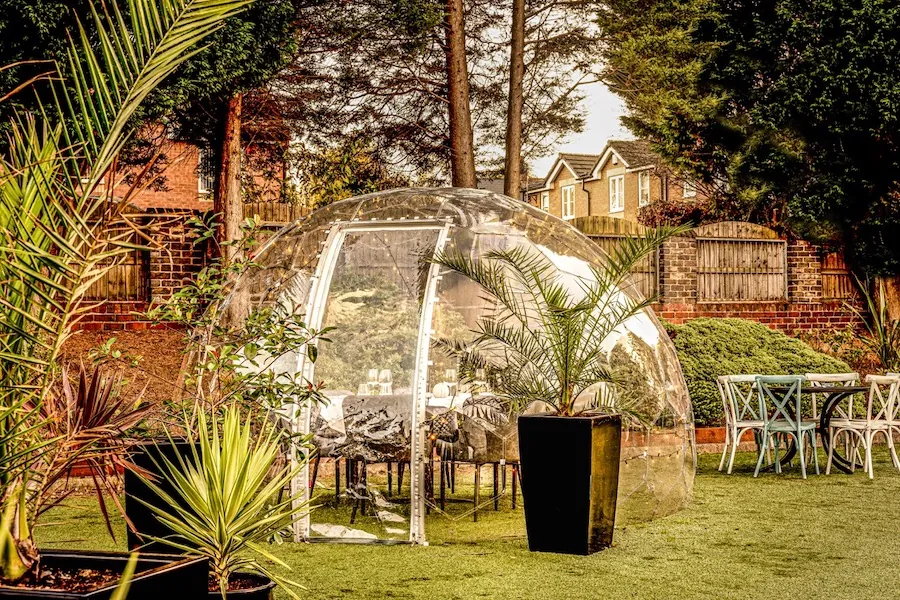 Dining pod in Lucarelli patio surrounded by buildings