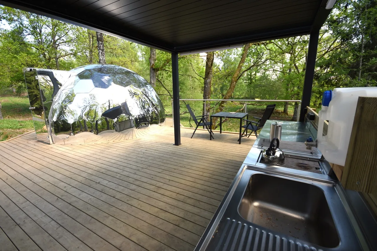 Outdoor bedroom dome on a large wooden deck