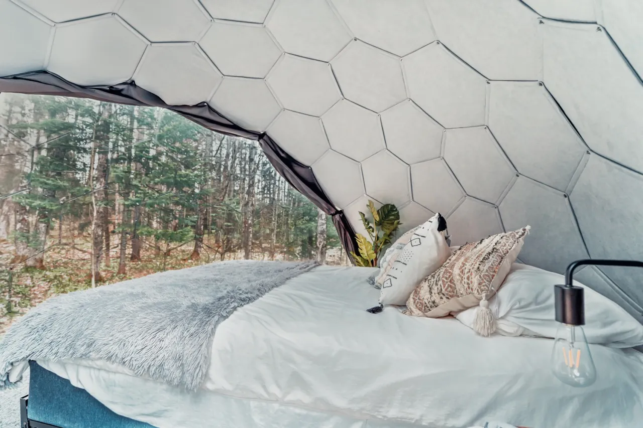 A glamping dome with insulated wall panels in the woods