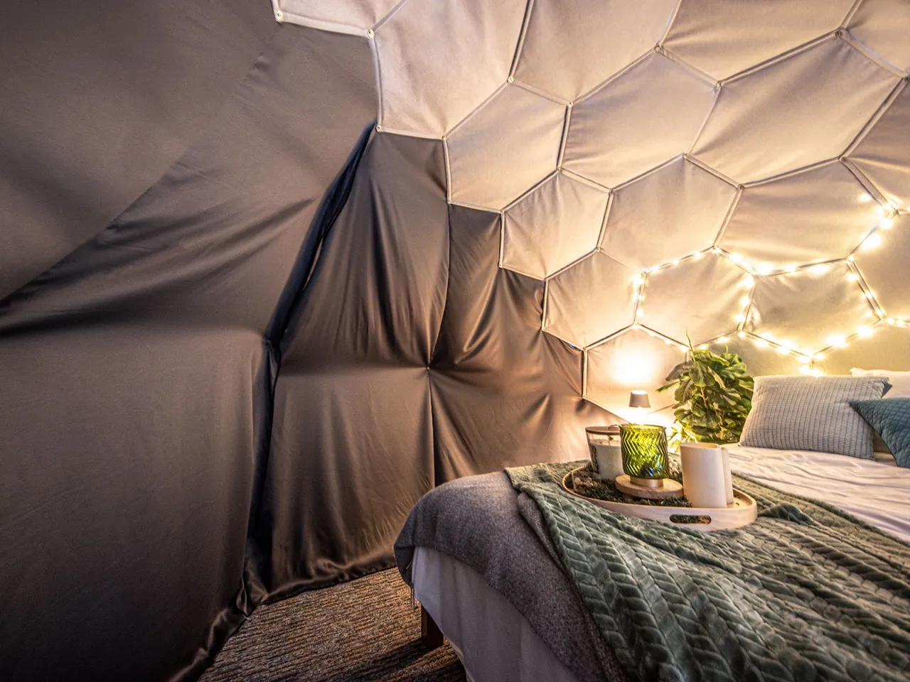 Insulated geodesic dome bedroom with privacy curtains and insulated wall panels