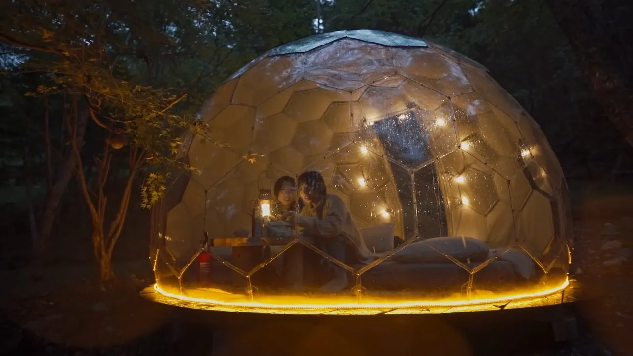 A cozy Hypedome by night with guests