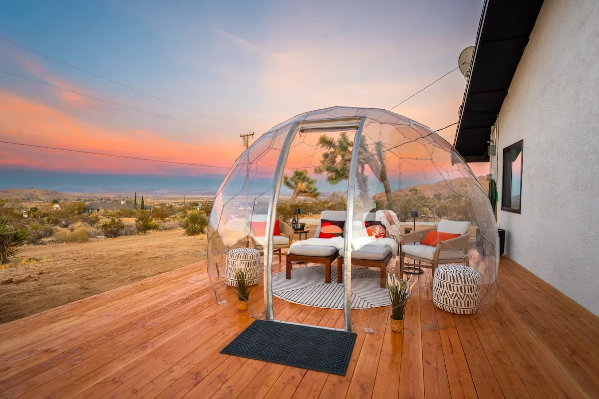 A beautiful outdoor lounge in a clear Hypedome in an Airbnb property