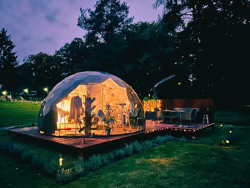 A beautiful Airbnb outdoor essentials dome with lights on