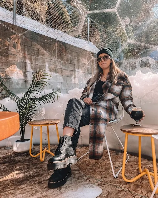 A woman having wine in a transparent dome in an apres-ski bar