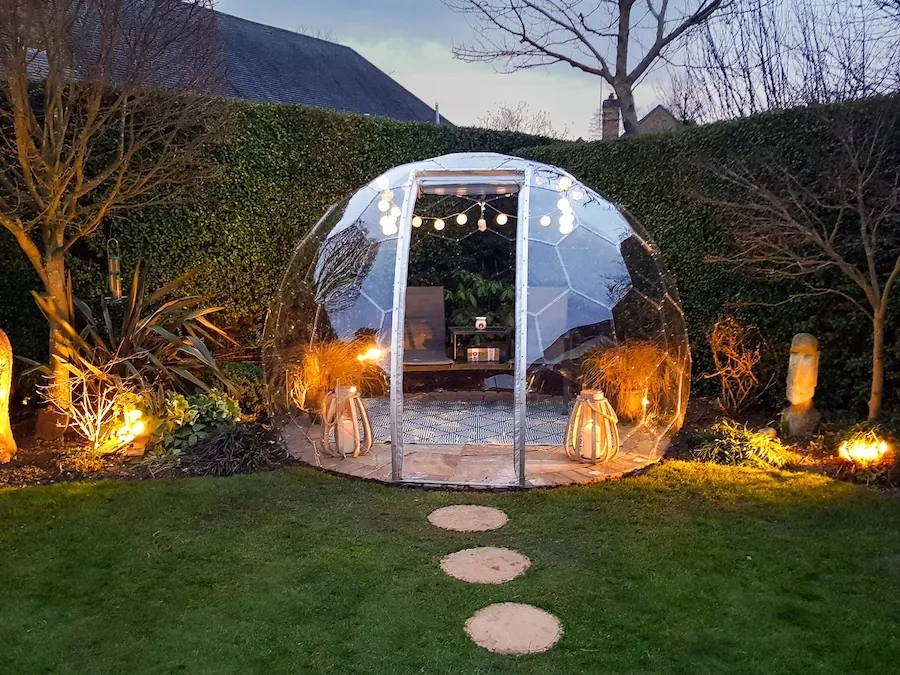 An outdoor room in a backyard used as a lounge