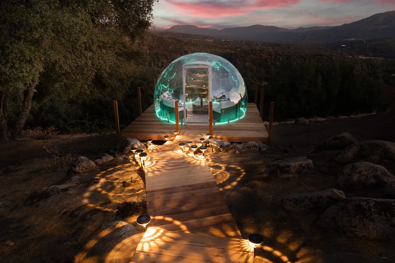 A beautifully lit path to the mountain view dome
