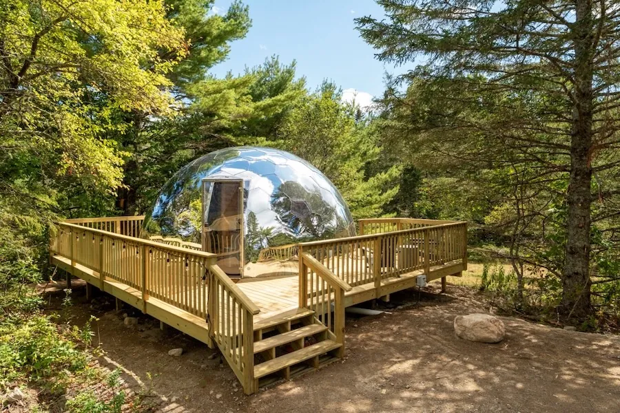 Mirror glamping dome on a wooden deck