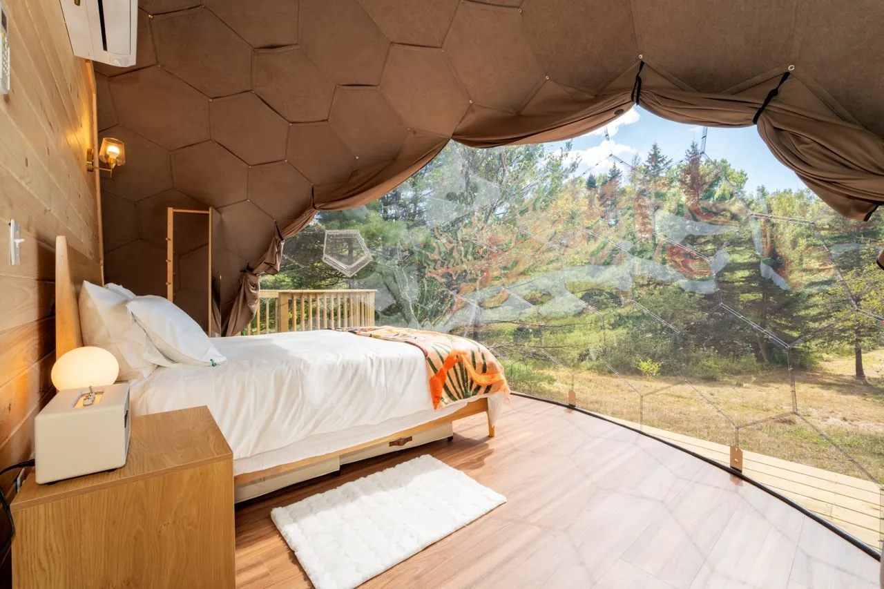 A view from a bay window from the inside of a glamping Nova Nook dome