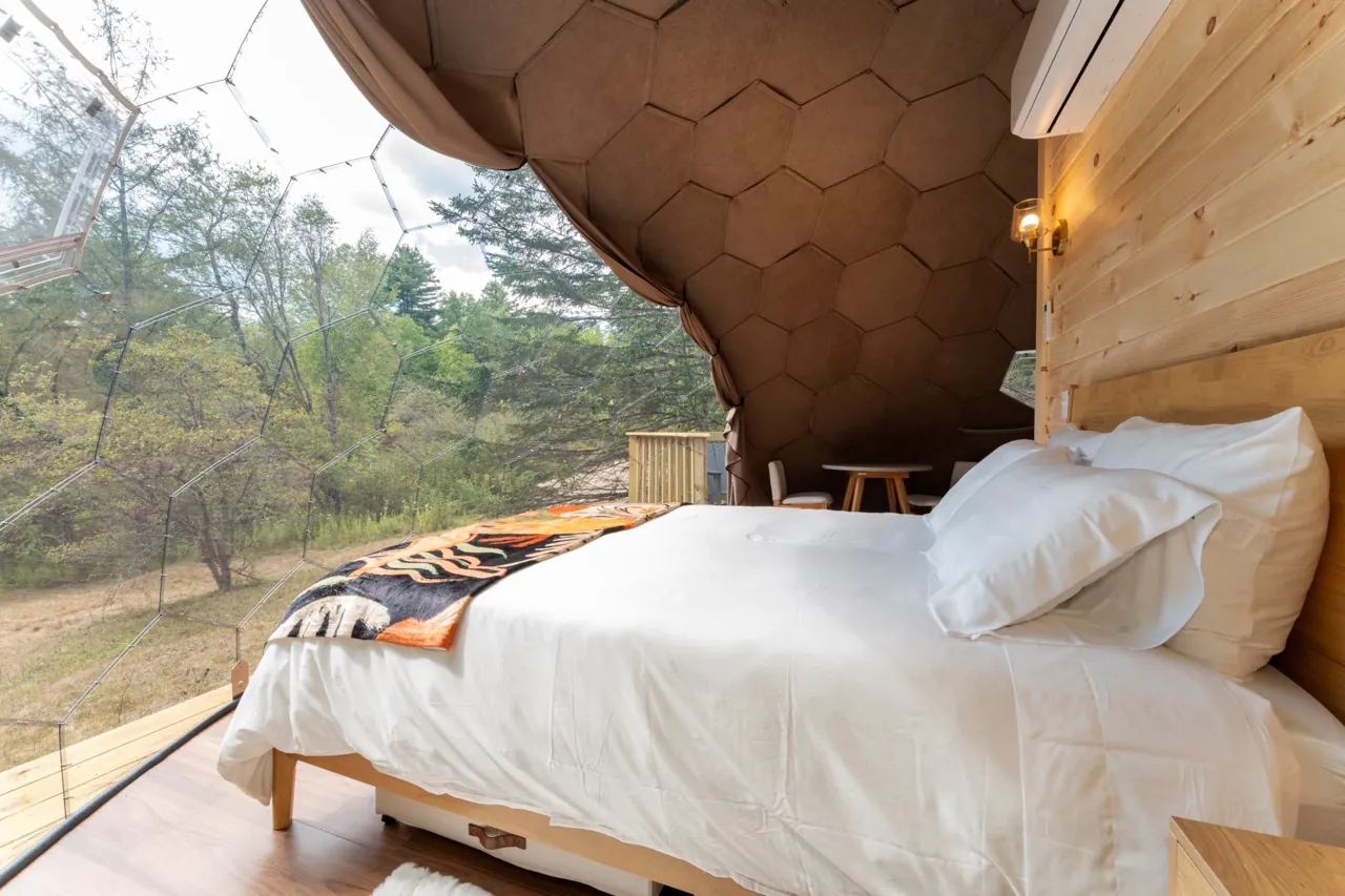 A bedroom section in a glamping dome suite Nova Nook