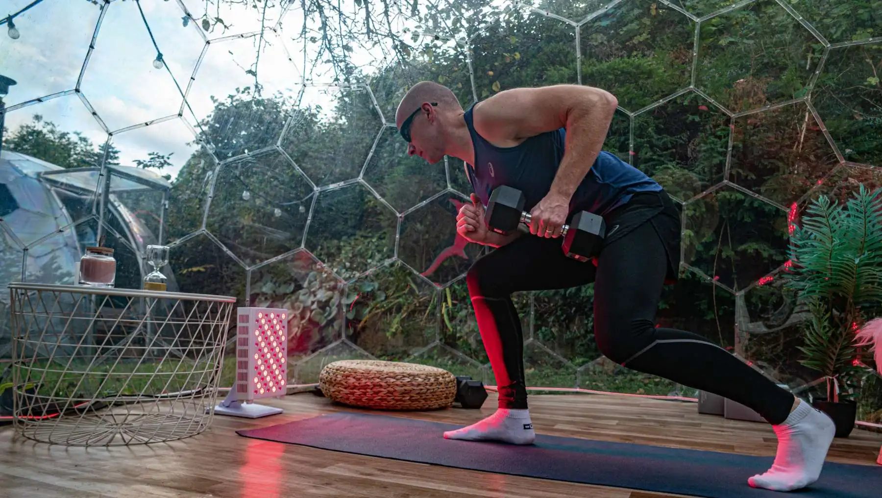 Outdoor workout in a Hypedome with red light, showing a backyard wellness retreat built for longevity